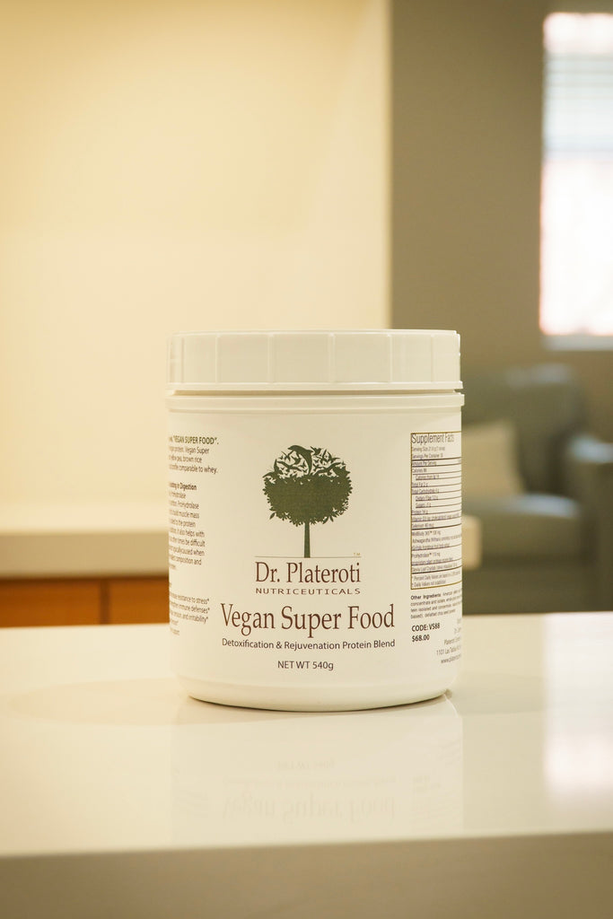 Container of Dr. Plateroti Vegan Super Food on a surface with a blurred background
